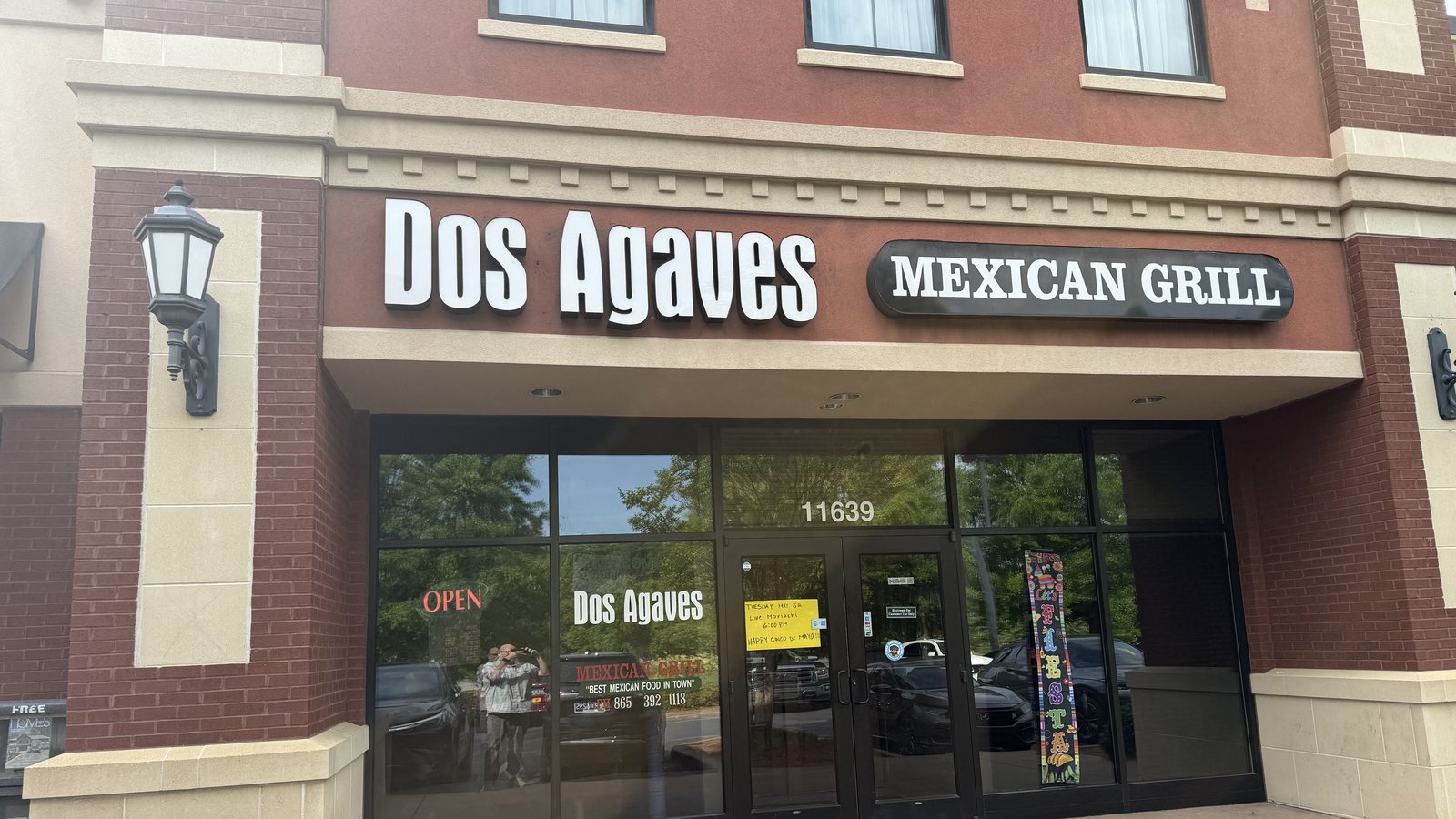 The brick storefront of Dos Agaves Mexican Grill at 11639 Parkside Drive in Farragut, Tennessee — the restaurant's white sign across a brown awning, an OPEN sign in the glass door, and the address number on the window.