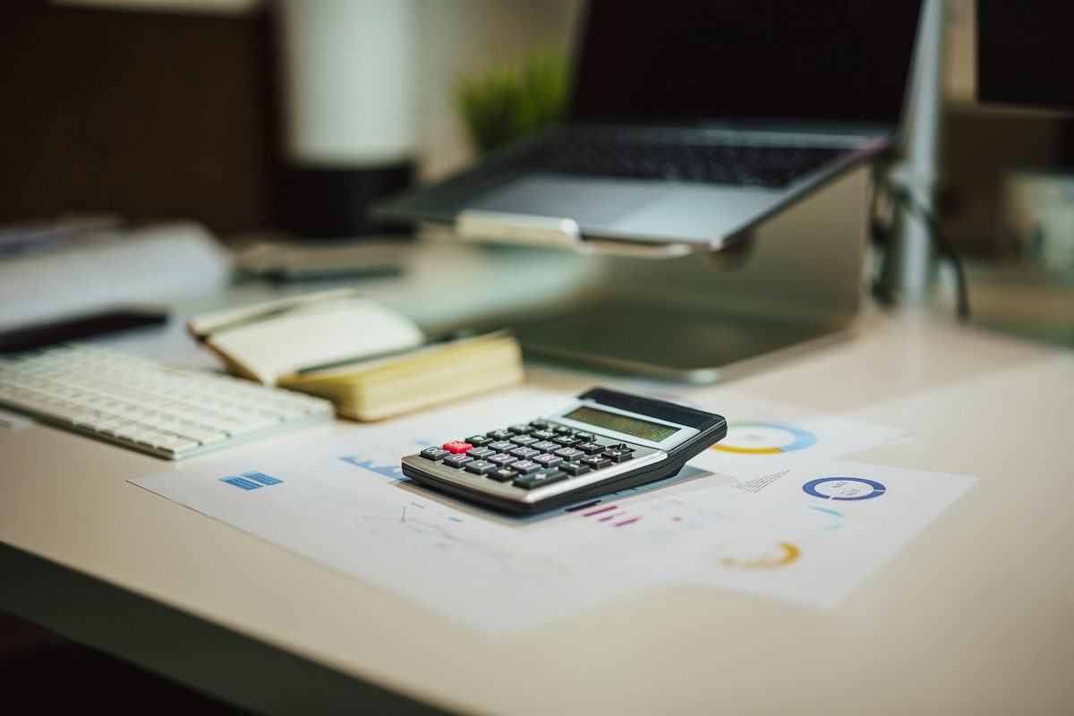 A first-time buyer's Saturday-morning kitchen-table moment — the calm vignette of running the math on a Knoxville home before touring a single house.