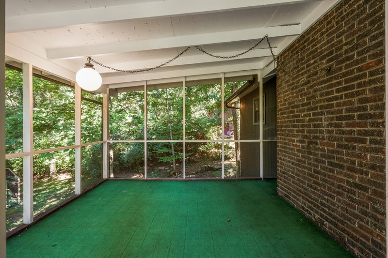 Screened porch overlooking the wooded backyard